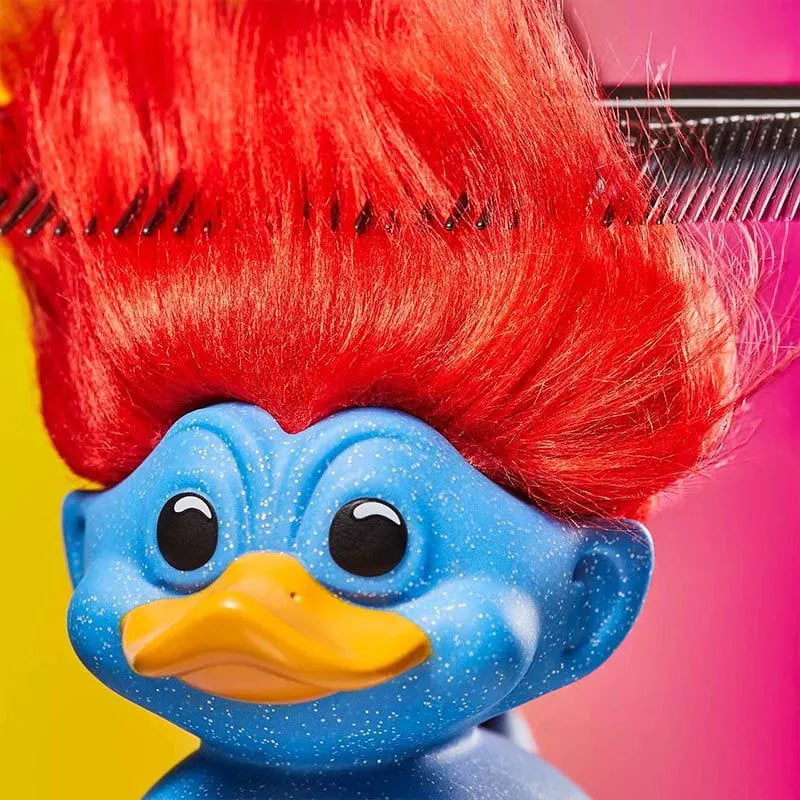 Close-up of red troll hair on glittery duck with comb