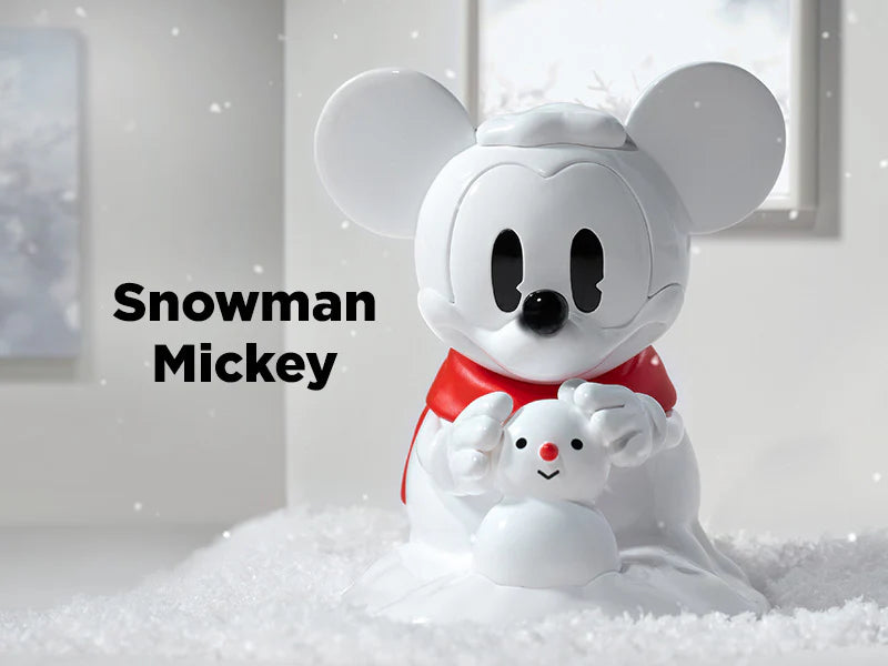 Snowman Mickey vinyl figure with a red scarf building a snowman from Disney 100th Anniversary Ever Curious Series.