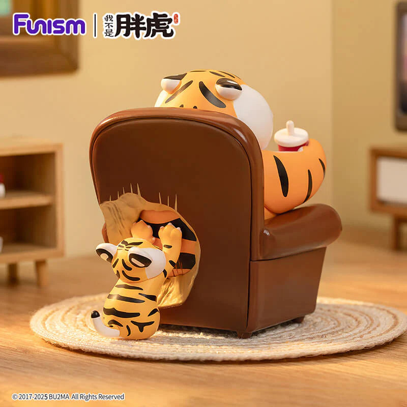 Back view of Fat Tiger figure relaxing in chair with baby tiger hiding behind.