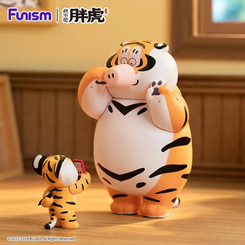 Fat Tiger vinyl art toy interacting with cub holding a phone collectible figure.