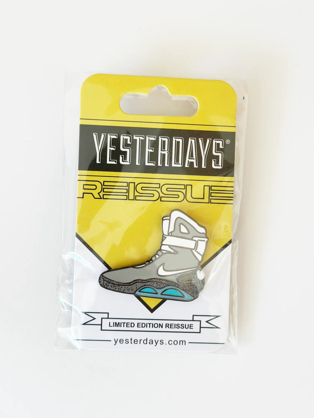 Back To The Boot Enamel Pin by Yesterdays in packaging, shaped like the futuristic self-lacing sneaker from classic sci-fi.