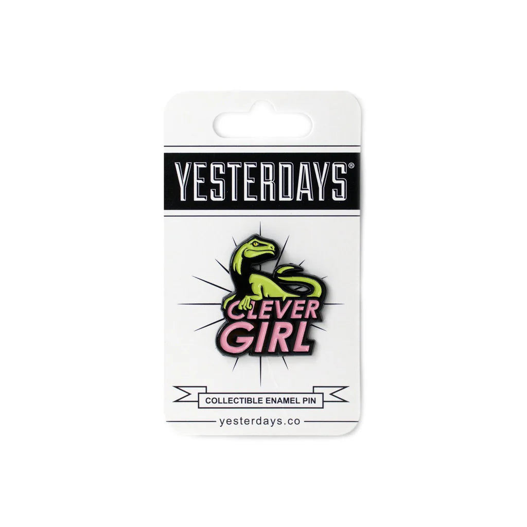 Close-up of Clever Girl enamel pin featuring green raptor and bold pink lettering