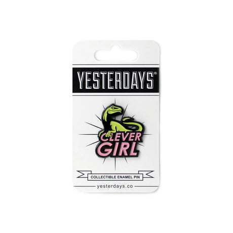 Close-up of Clever Girl enamel pin featuring green raptor and bold pink lettering