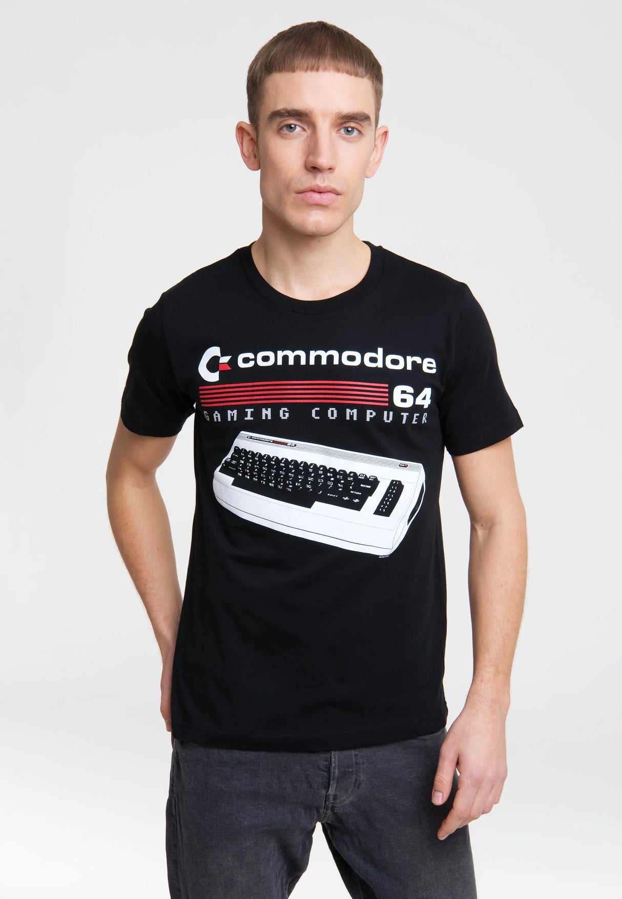 Male model wearing black Commodore 64 Gaming Computer T-Shirt with retro keyboard design.