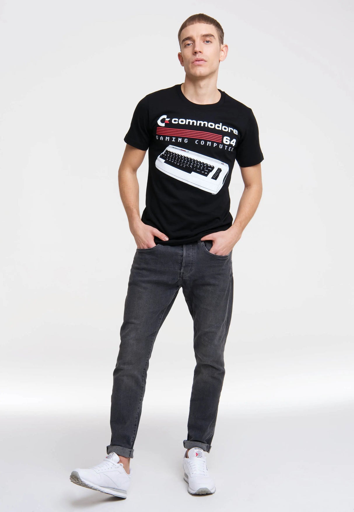 Full body shot of model in Commodore 64 Gaming Computer T-Shirt styled with jeans and sneakers.