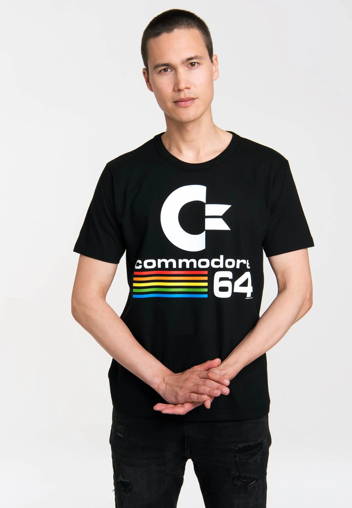 Model wearing black Commodore 64 logo t-shirt with colorful retro stripes