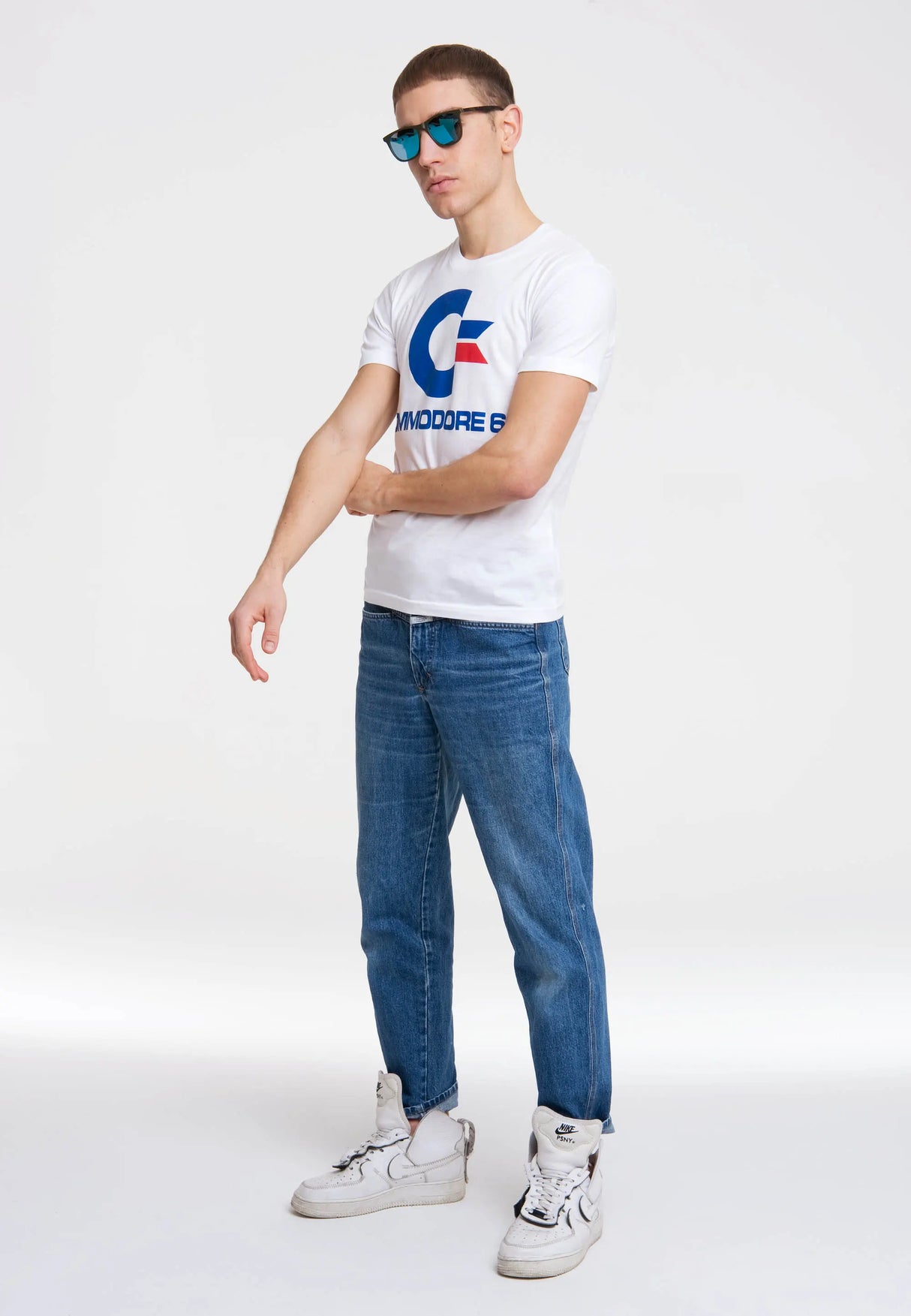 Model styling the white Commodore 64 T-Shirt with blue jeans and sneakers.