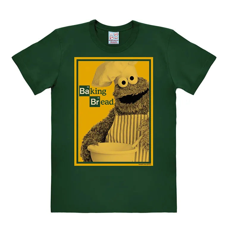 Cookie Monster “Baking Bread” parody T-shirt in green featuring Cookie Monster in a chef outfit mixing dough.
