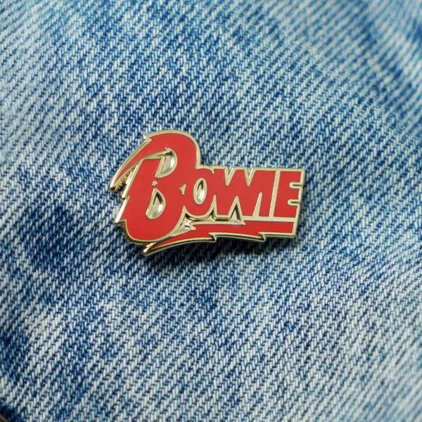 David Bowie Diamond Dogs logo enamel pin on denim jacket pocket