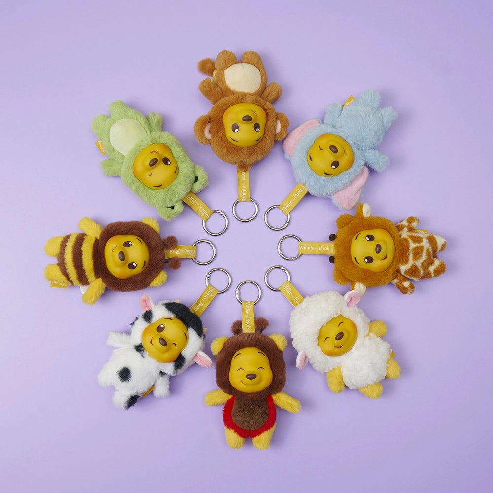 Disney YuYus Winnie the Pooh plush keychains arranged in circular layout on pastel background