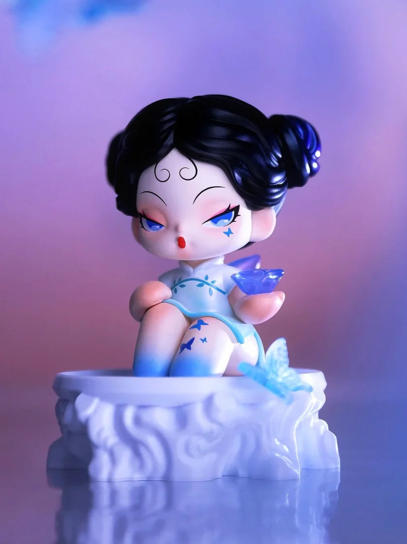 DODO Nami vinyl figure with black hair buns, blue dress, and butterfly crystal theme.