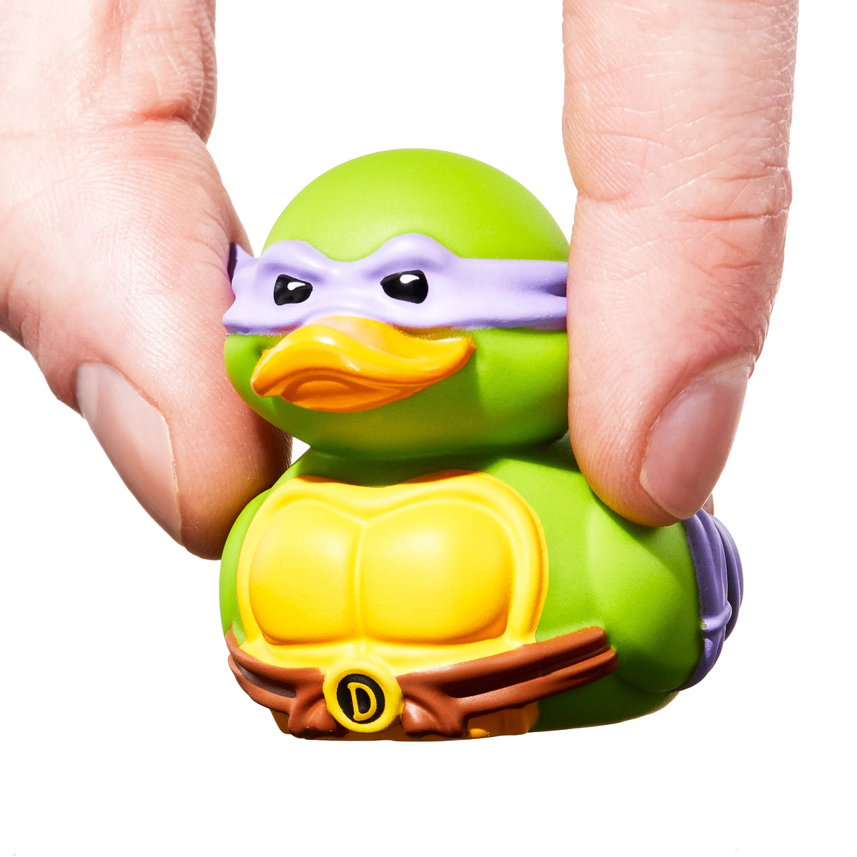 Donatello duck vinyl figure being gently squeezed between fingers