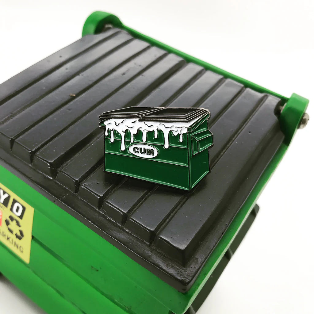 Close-up of Dumpster Enamel Pin on mini dumpster lid