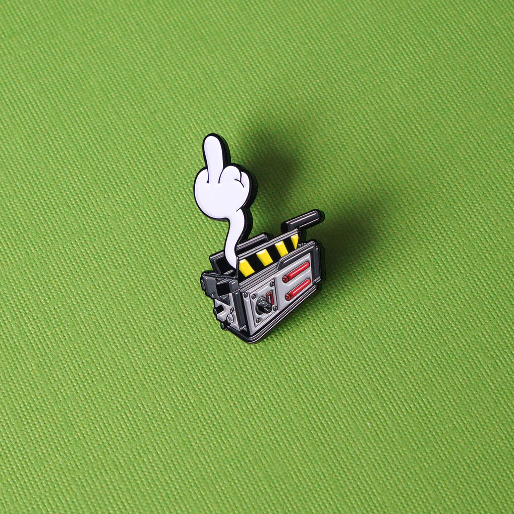 Close-up of Ghostbusters-inspired ghost trap pin with glow feature