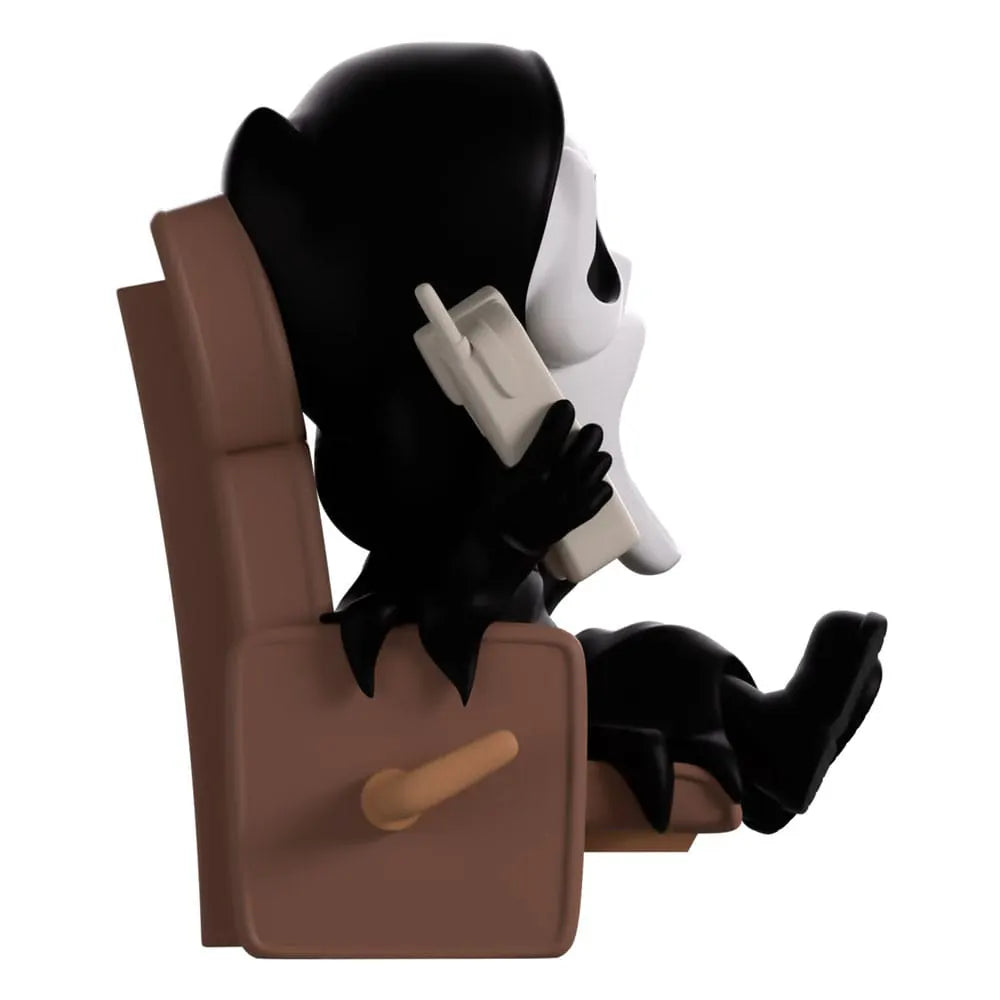 Side view of Ghostface lounging vinyl figure with classic phone