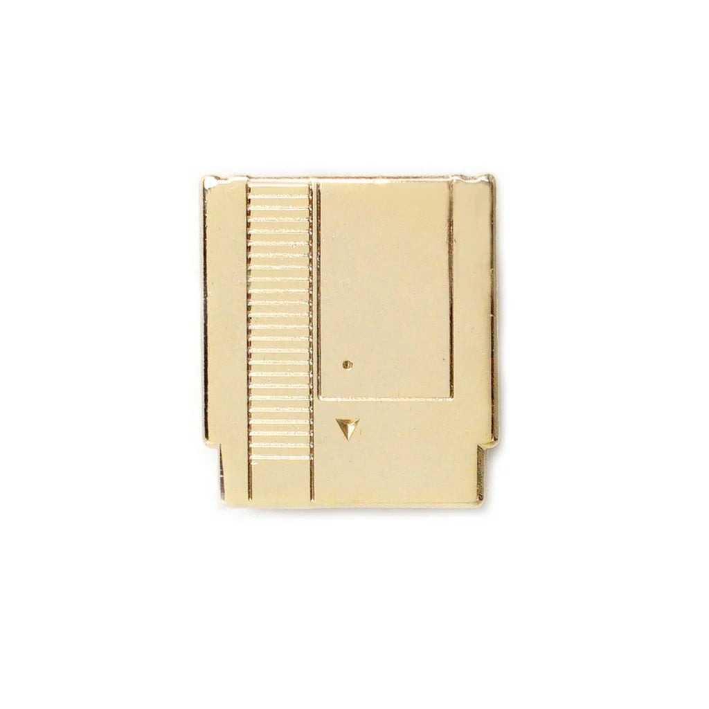 Gold NES-style enamel pin shaped like a retro game cartridge