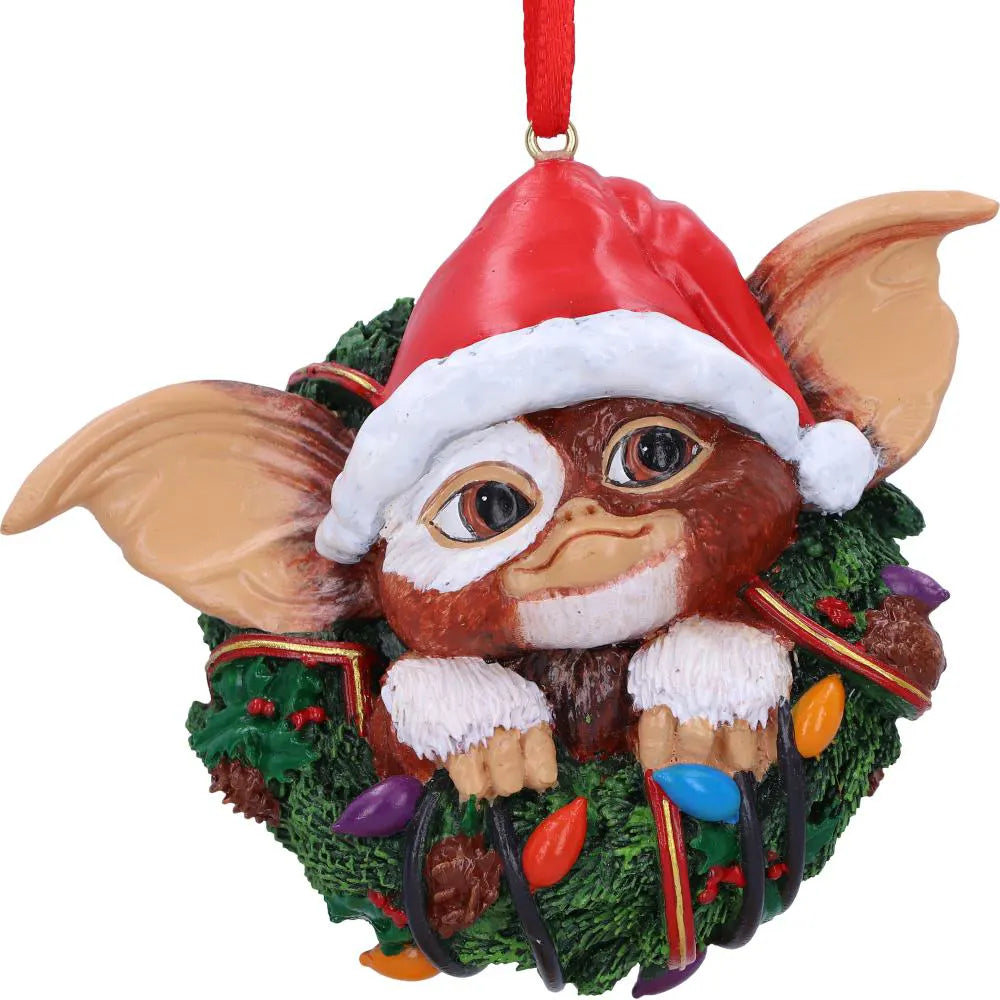 Close-up of Gizmo wearing a Santa hat in a festive wreath