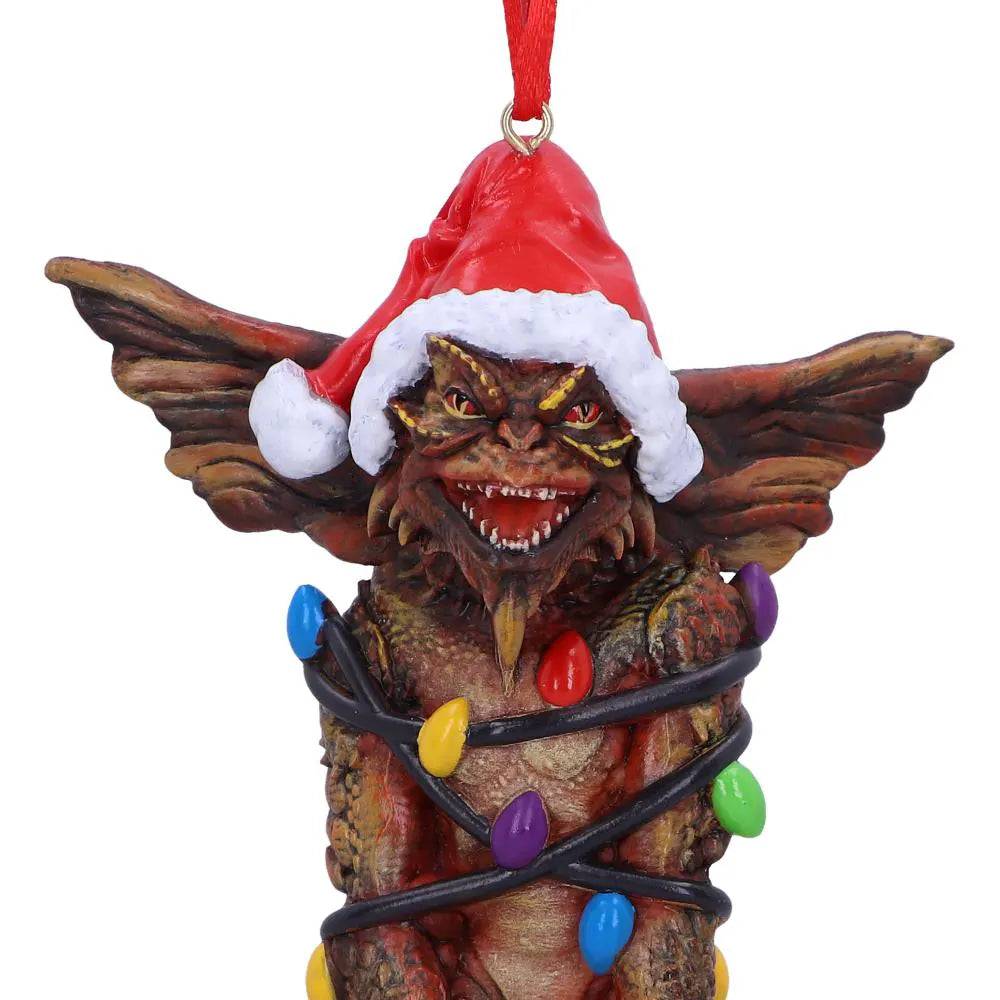 Close-up of Mohawk Gremlin wearing a Santa hat wrapped in Christmas lights