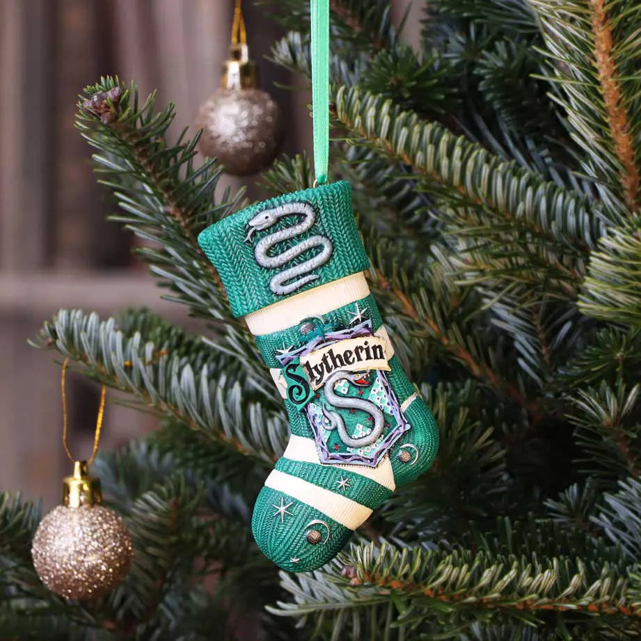 Slytherin stocking ornament hanging on a Christmas tree with festive baubles