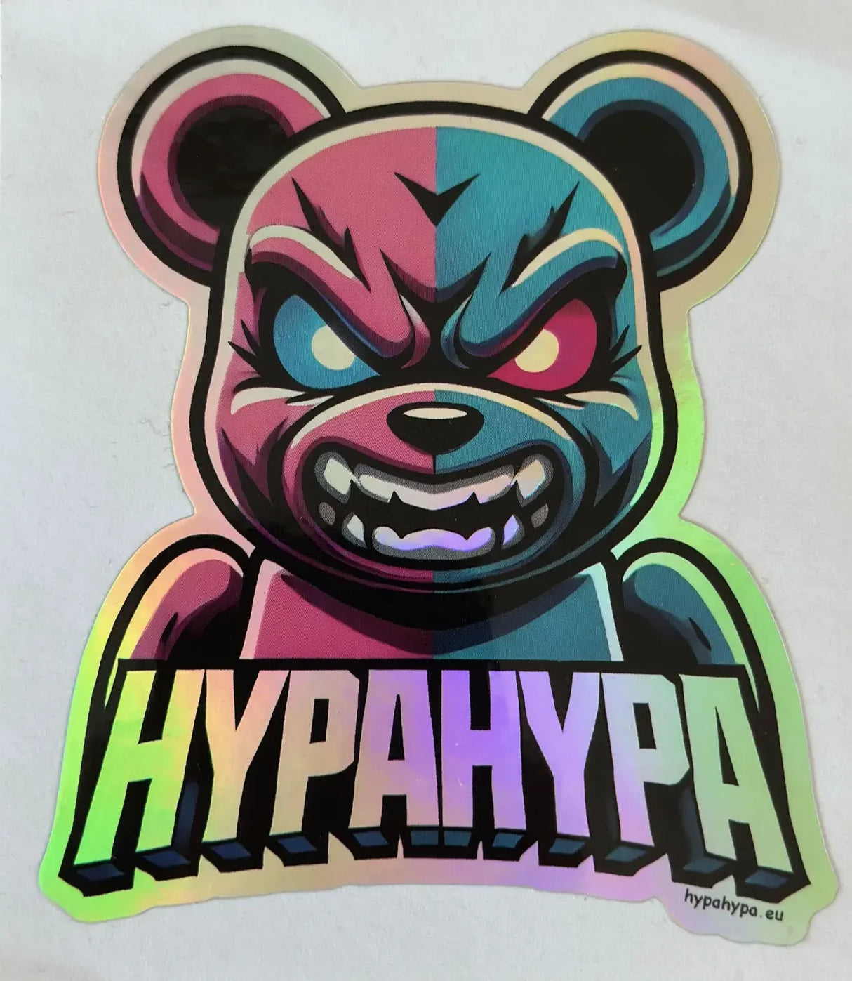 Close-up of HypaHypa holographic bear sports logo sticker with fierce pink and blue bear design and shimmering rainbow finish.