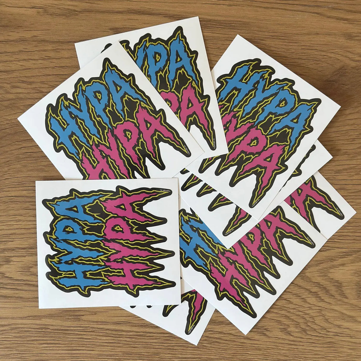 HypaHypa splat logo sticker pack showing multiple stickers stacked on a wooden surface.