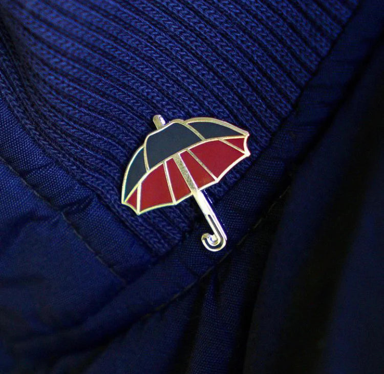 Close-up of umbrella pin worn on clothing