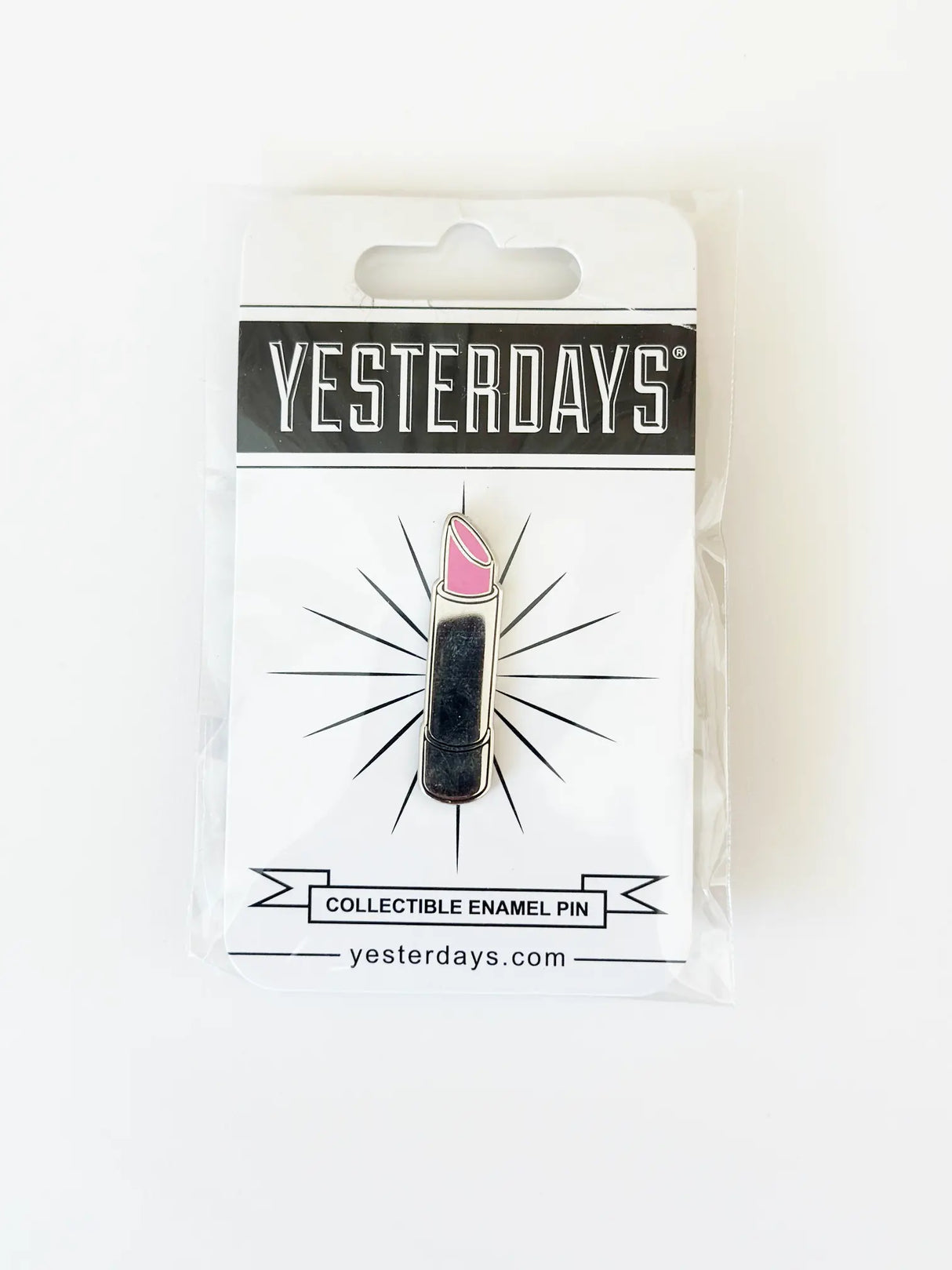 Lipstick Enamel Pin by Yesterdays in packaging, featuring a silver and black lipstick tube with a bright pink top.