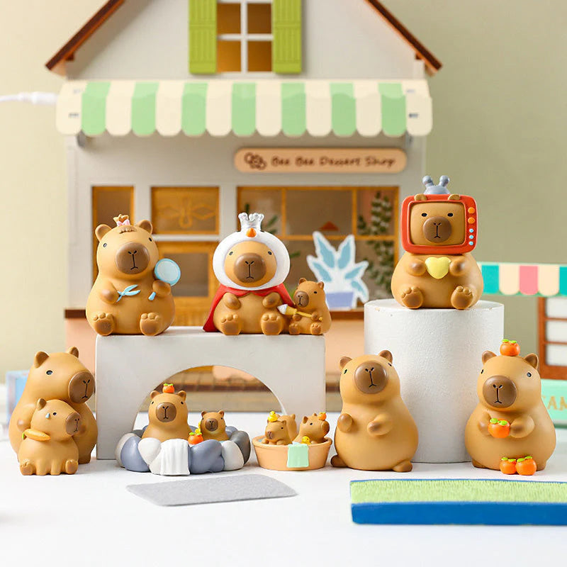 Group display of Little Bean Capybara Series figures arranged in front of a small shop backdrop.