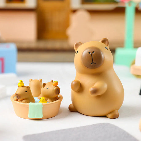 Close-up of Baby Capybara vinyl figures playing in a bathtub with rubber ducks.