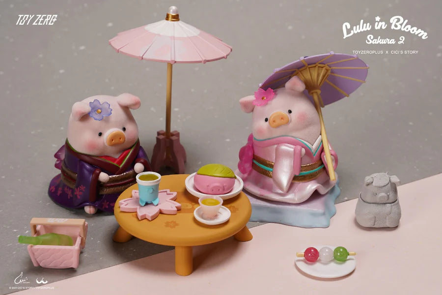 Close-up of two LuLu The Piggy Sakura 2 figures in kimono enjoying tea and sweets under parasols.