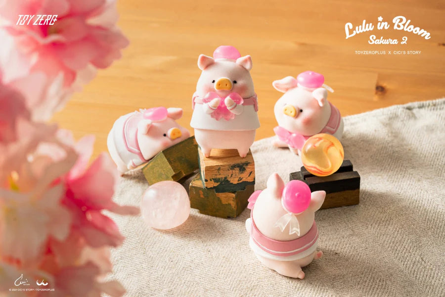 LuLu The Piggy Sakura 2 blind box figure standing on wooden blocks with sakura decorations.