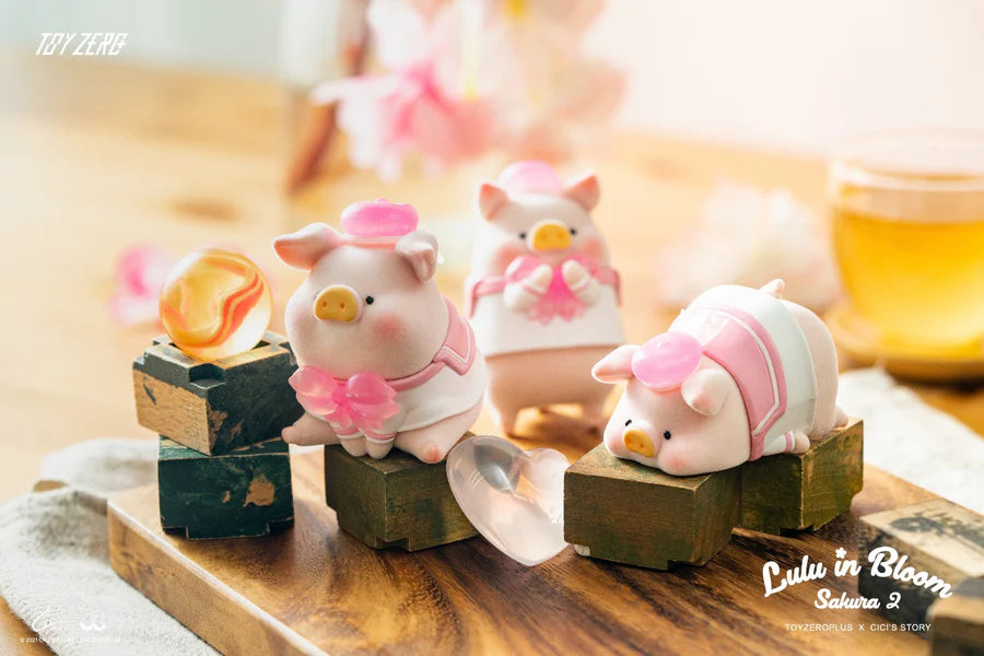 Group of LuLu The Piggy Sakura 2 figures posing together on wooden blocks with cherry blossom details.