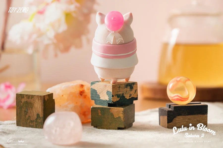 Multiple LuLu The Piggy Sakura 2 blind box figures with floral details and props in springtime setting.