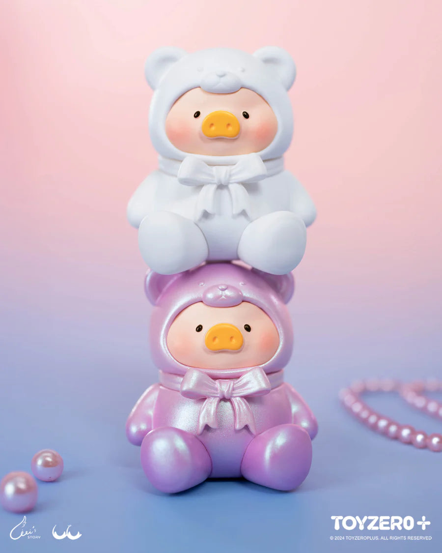 White and pearl pink LuLu The Piggy teddy bear mini figures stacked together on a pastel background