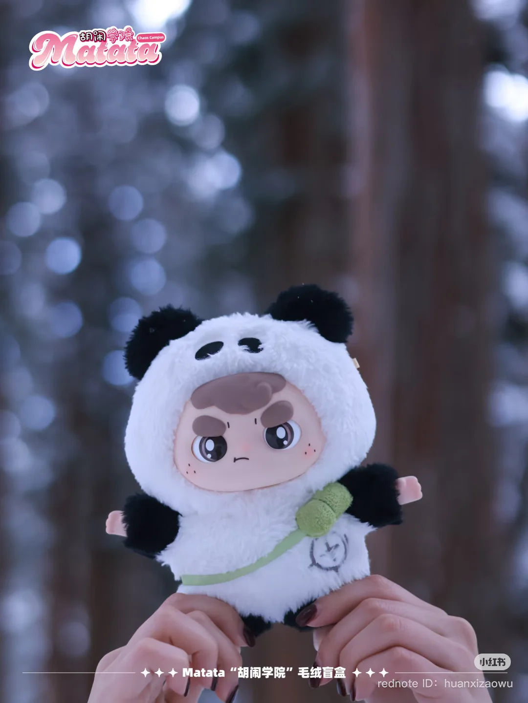 Matata Chaos Campus plush keychain in panda costume held outdoors in winter
