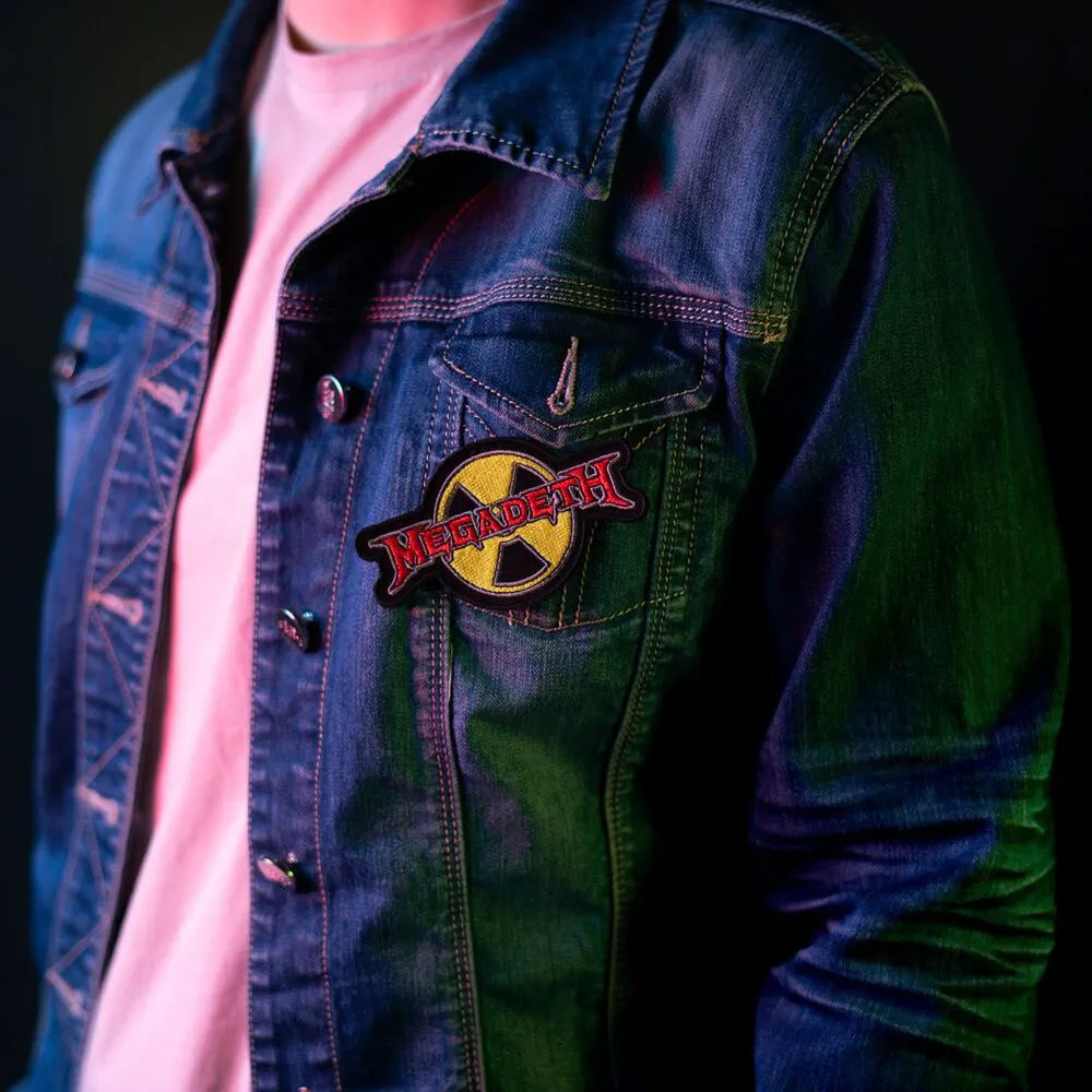 Megadeth radioactive logo patch applied to a denim jacket front pocket