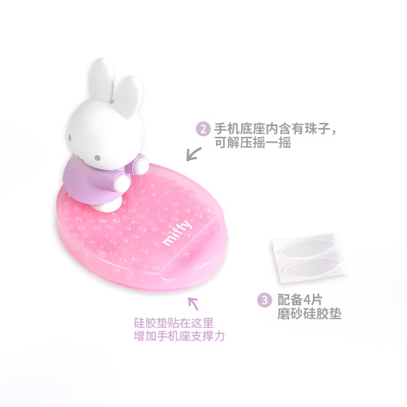 Close-up of pink pearlescent Miffy phone stand base showing decorative beads and support accessories