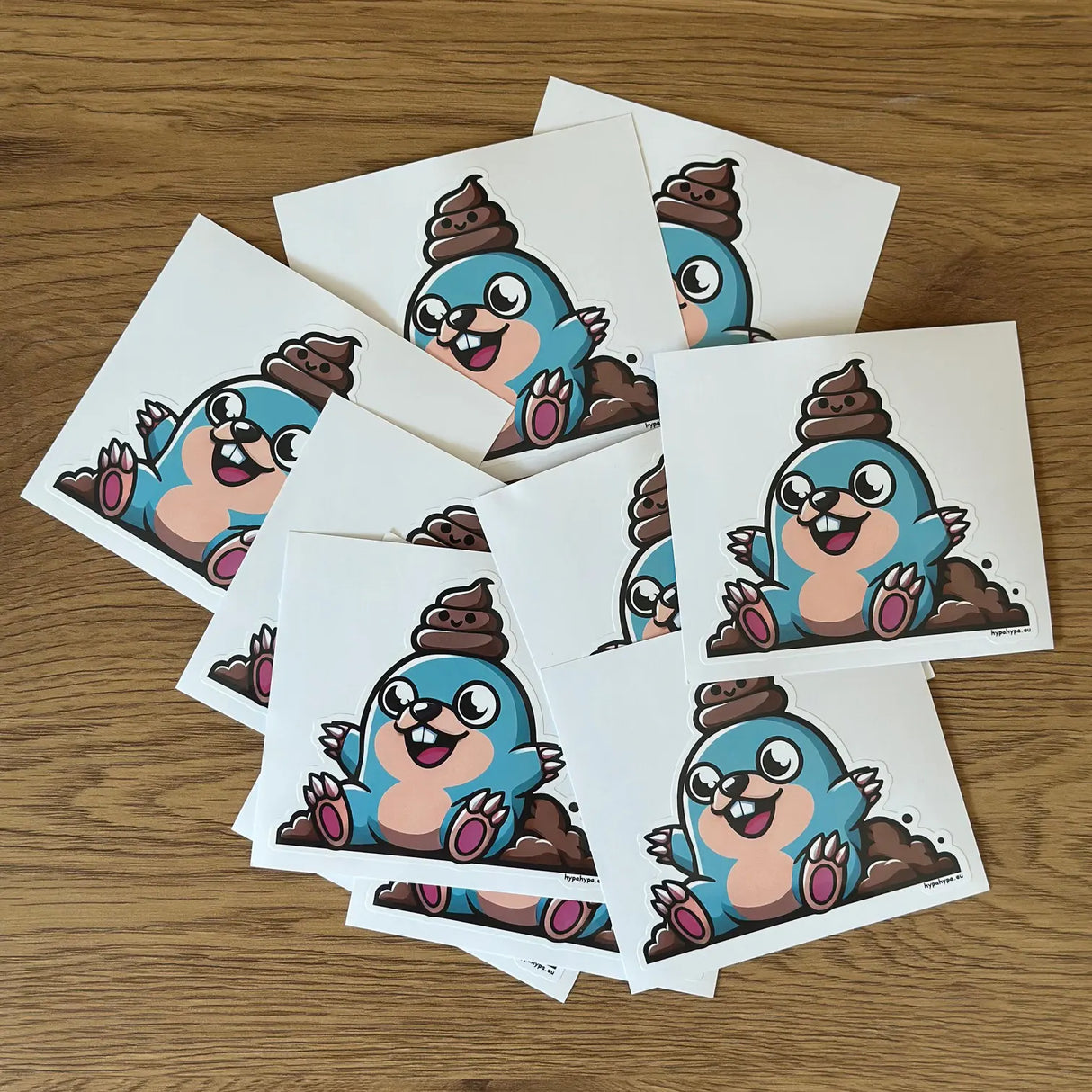 10-pack of The Mole with a Poo On It's Head stickers displayed on a wooden surface.