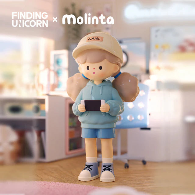 Molinta gaming figure holding a handheld game console in a pastel bedroom