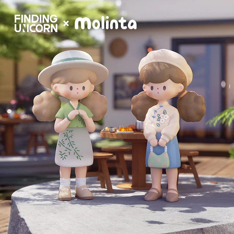 Two Molinta figures enjoying a sunny patio, one in green dress, one in floral sweater.