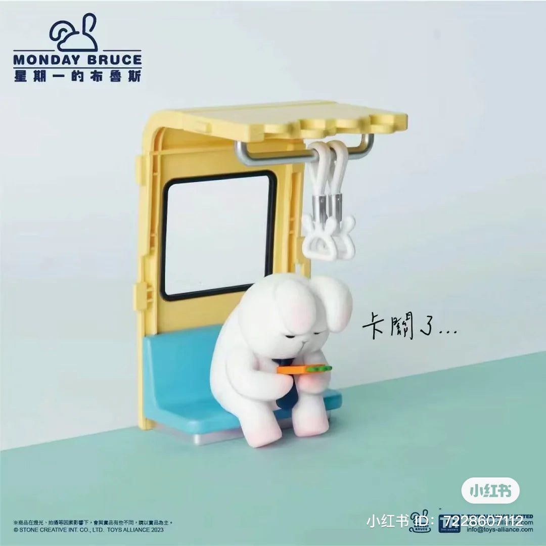 Monday Bruce bunny figure sitting on subway bench playing handheld console