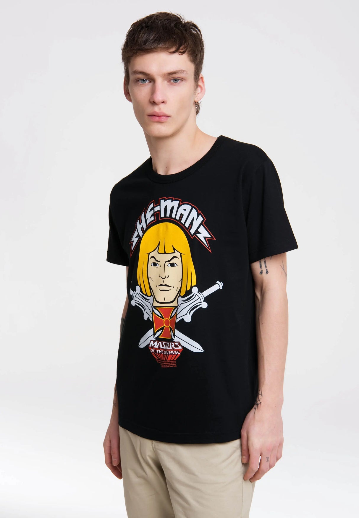 Model wearing the Masters of the Universe He-Man Face T-Shirt with bold He-Man portrait print