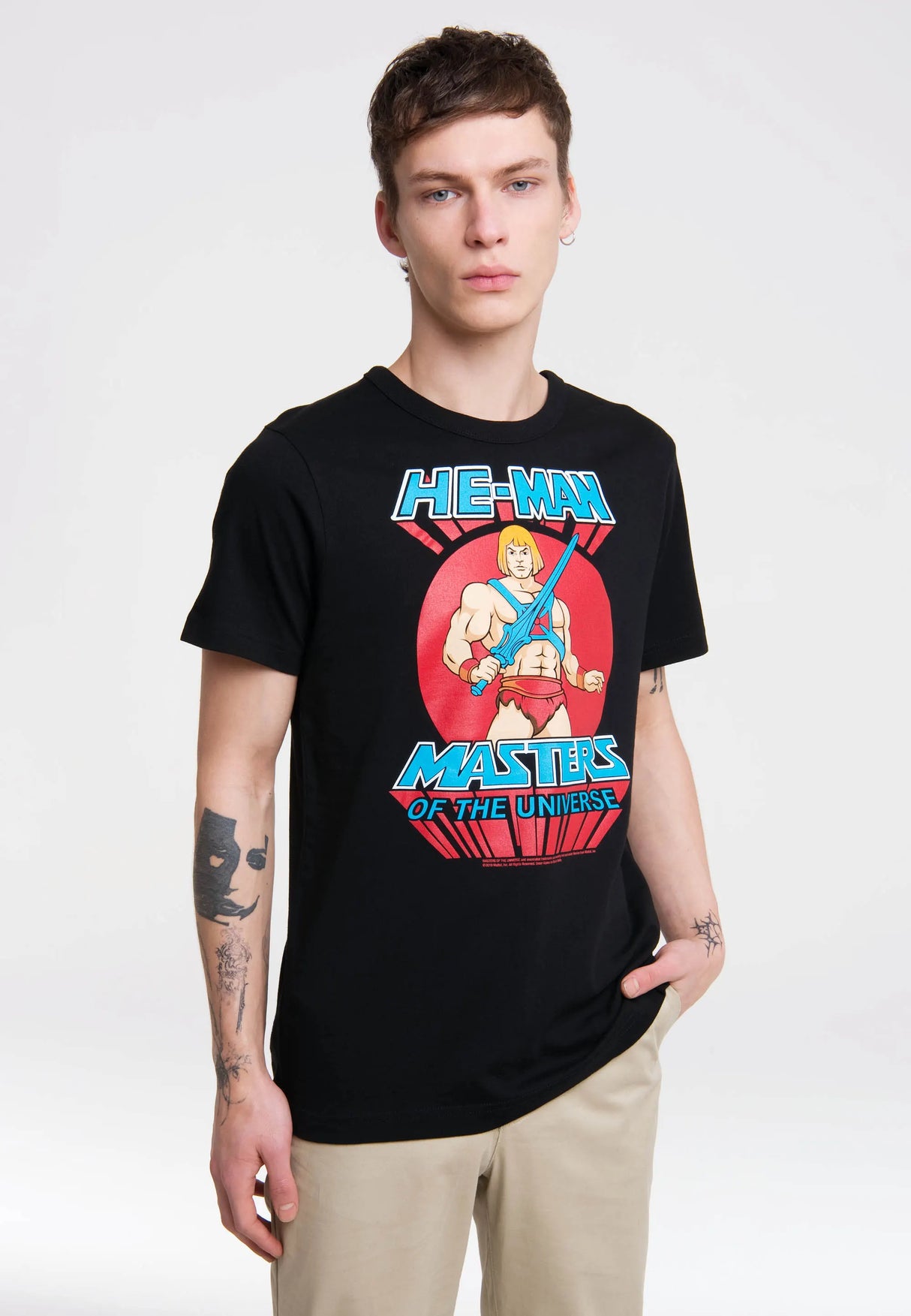 Model wearing Masters of the Universe He-Man T-shirt with colorful retro cartoon design