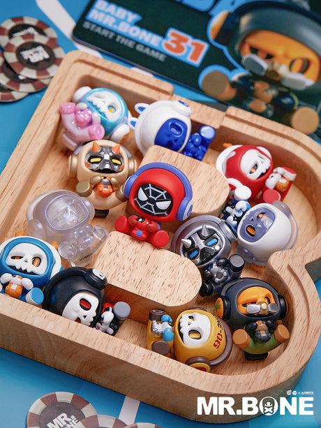 Baby Bone vinyl figures displayed in a wooden tray with multiple colorful characters.