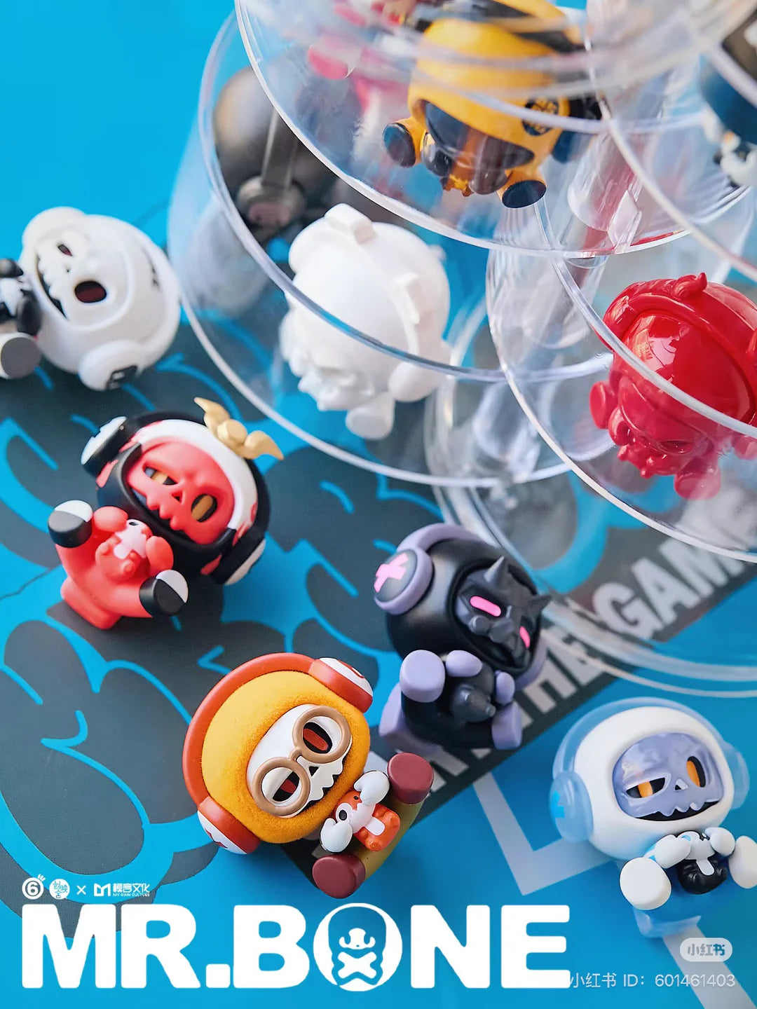 Group of Baby Bone blindbox figures lying and standing on a blue game-themed display surface.