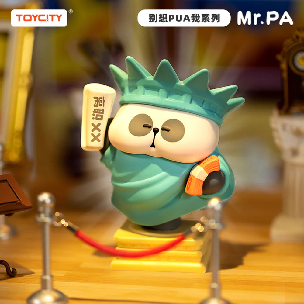 Mr. Pa vinyl figure dressed as the Statue of Liberty holding a book and fan from the Don’t Try To PUA Me Blindbox series by Toycity