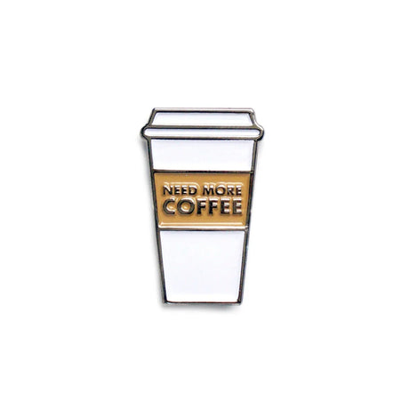 White enamel coffee cup pin with "NEED MORE COFFEE" text in gold.