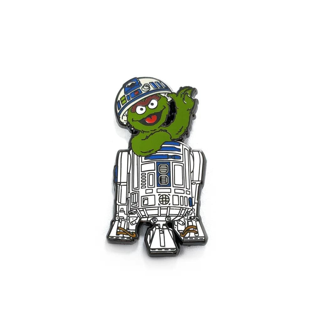 Hard enamel pin featuring green monster inside space droid