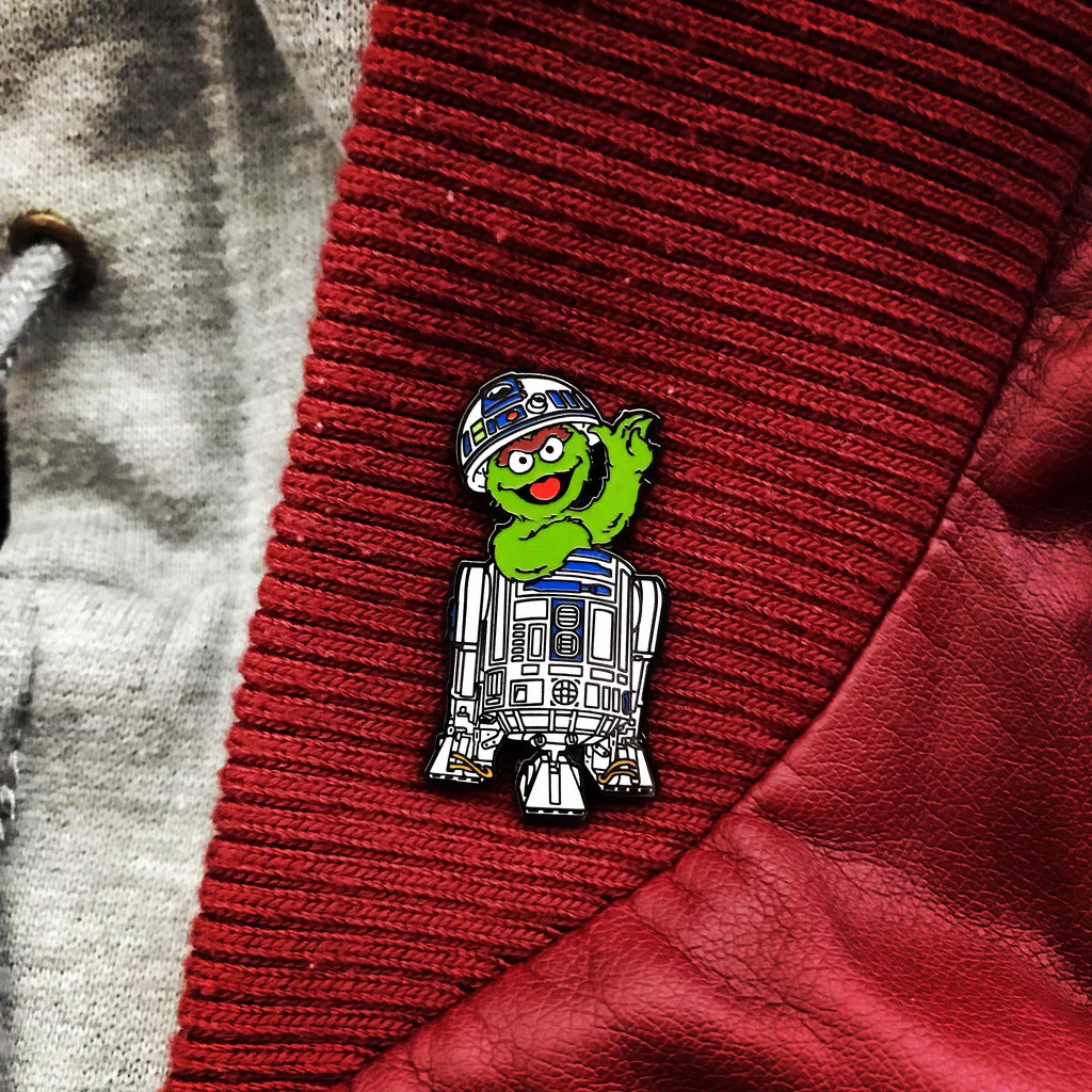 Pop culture crossover enamel pin styled on outerwear
