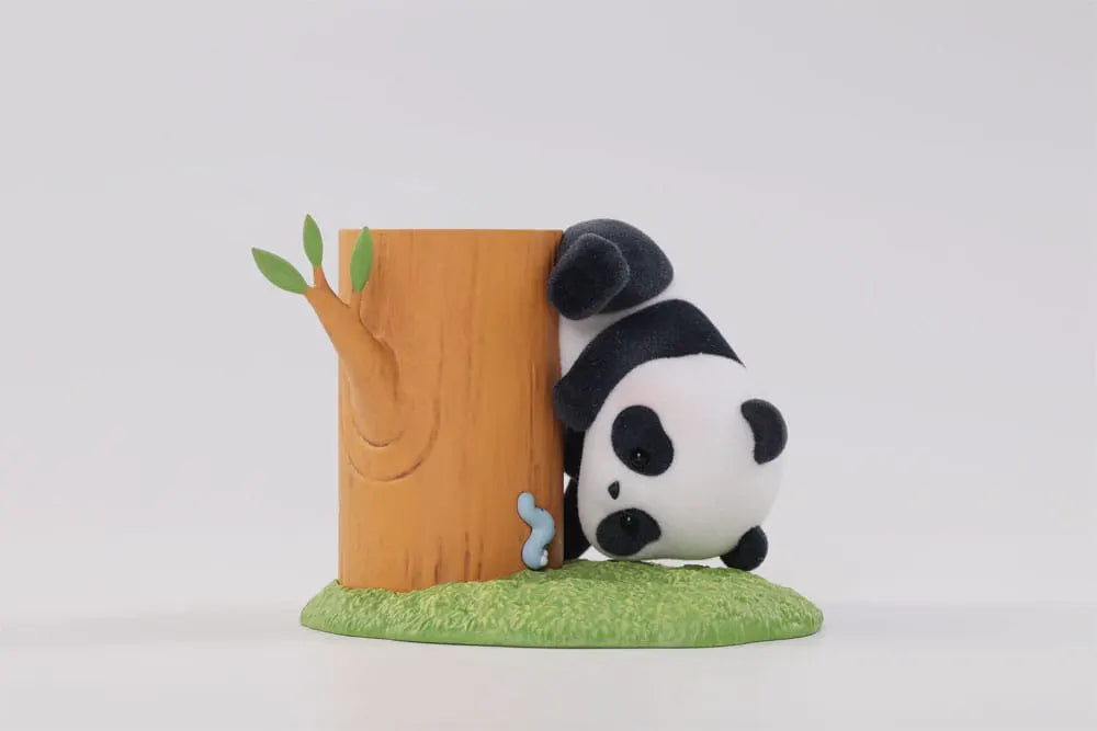 Panda Roll figure peeking from behind a wooden stump with caterpillar